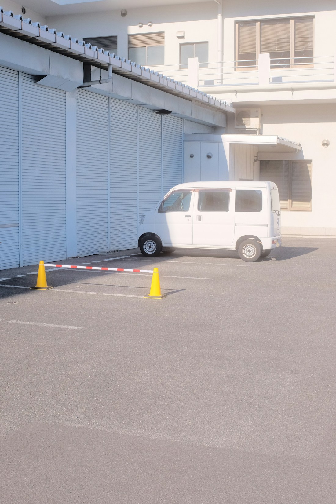 White electrical service van parked outside a building